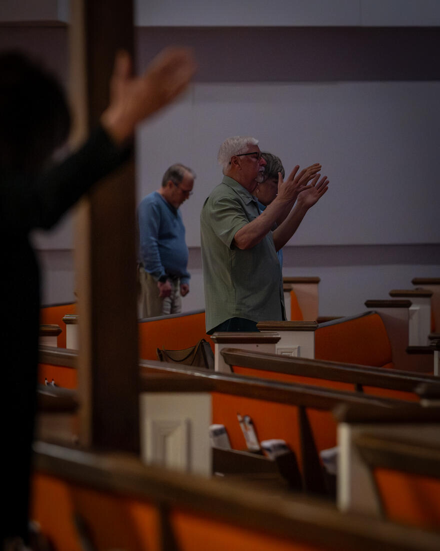 Hands raised in the pews