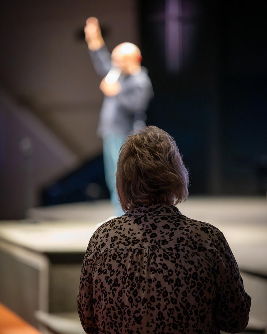 A hand lifted while the worship leader sings