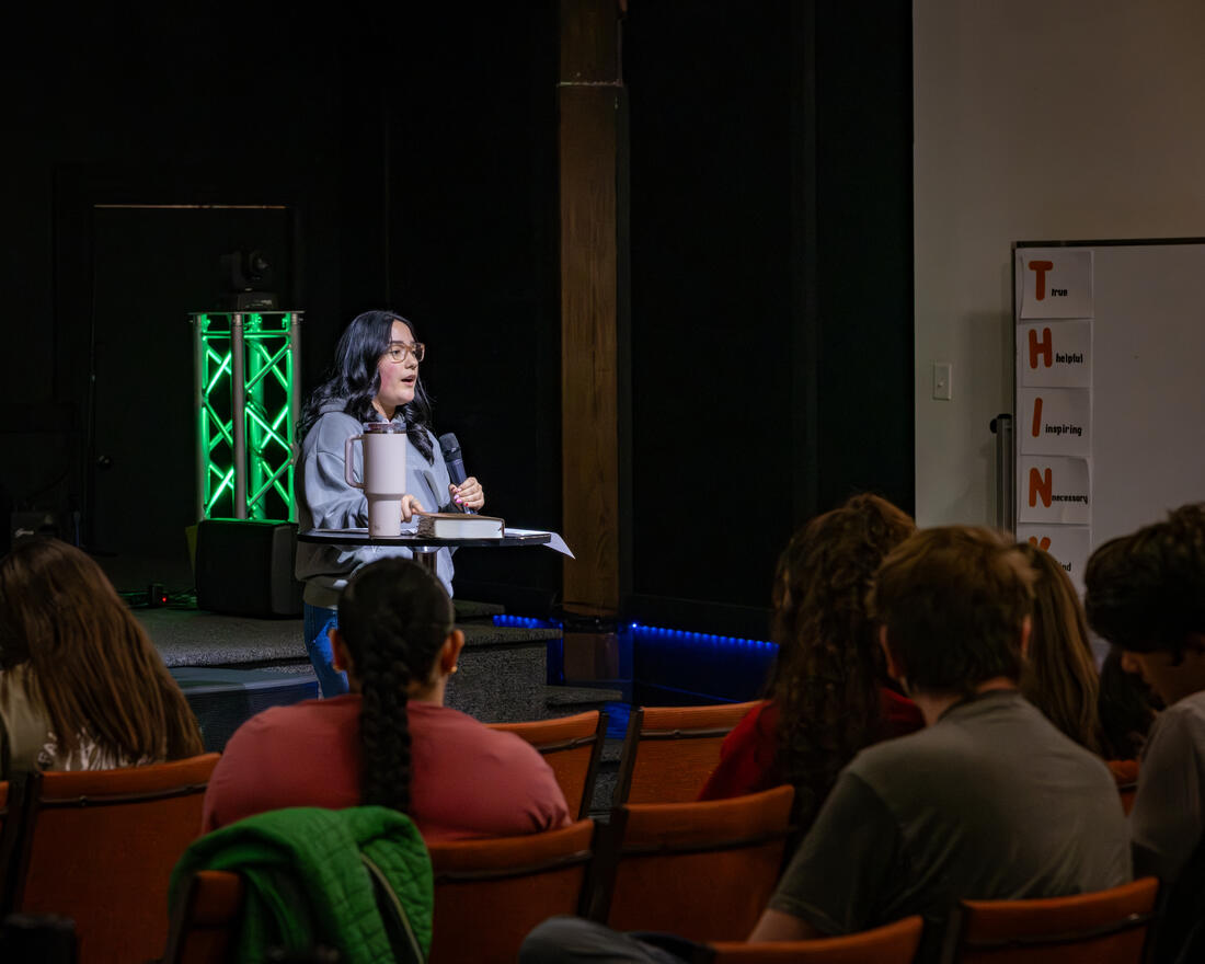 A student speaking with an open Bible